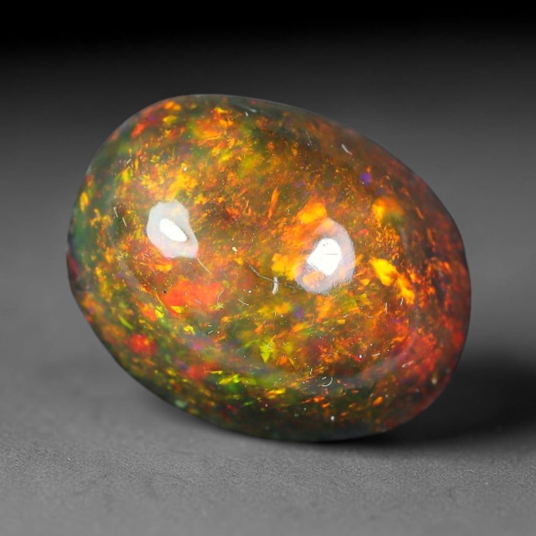 2.43ct Natural Ethiopian Welo Black Smoked Opal Cabochon Loose Gemstone, 17FX: This fully polished Ethiopian Welo opal features a dark smoked base with vivid, sweeping play-of-color shifting across its glossy dome surface, measured at 10x8x5mm. The black smoke treatment deepens 