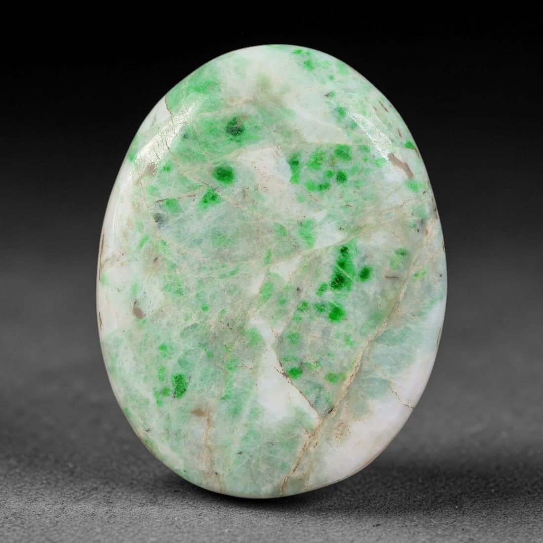 28ct Natural Burmese Type A Green Speckled White Ice Jadeite Jade Cabochon, 31FA: This single untreated natural Burmese Type A oval jadeite jade cabochon weighs 28ct with dimensions of 28x21.6x5mm. It features a pale milky white ice base naturally scattered with vivid bright green 