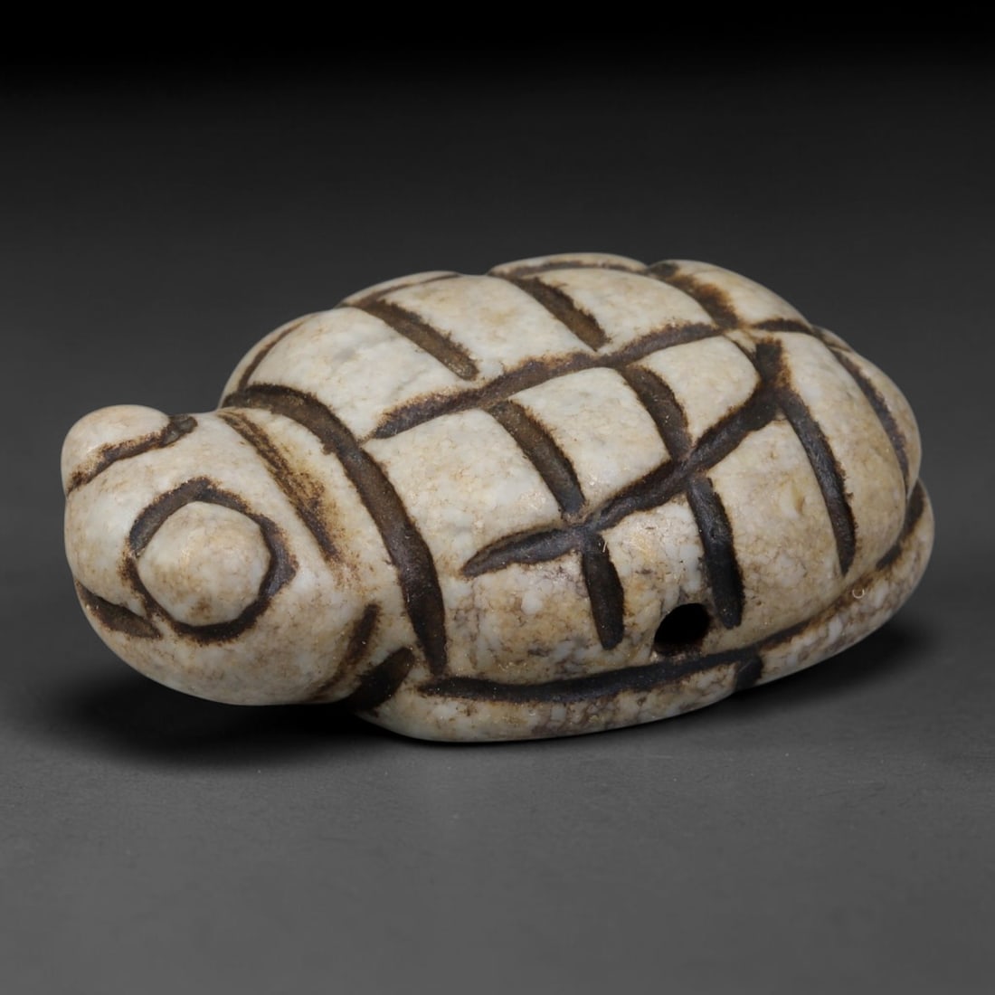 Ancient East Asian White Stone Turtle Zoomorphic Amulet (Pre-Medieval 200 BCE-600 CE), 49AB: Hand-carved pale creamy mineral stone pendant shaped as a stylized turtle, a sacred symbol of longevity, stability and protection. Deep incised grid lines delineate segmented shell plates and rounded 