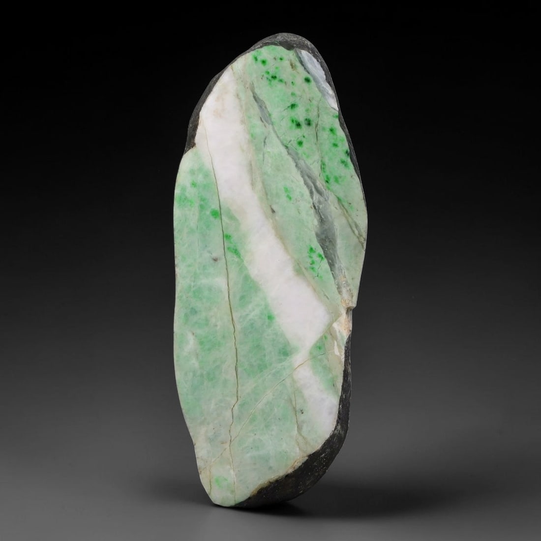 285ct Natural Type A Burmese Jadeite Jade Sliced Rough, 49AZ: This specimen is a sliced rough block of natural Type A Burmese jadeite jade. The interior displays natural colour zoning with visible mineral veining and crystalline patterns typical of unprocessed j