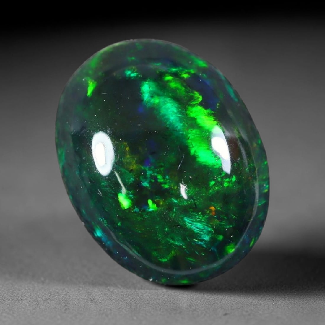 2.78ct Natural Ethiopian Welo Black Smoked Opal Cabochon Loose Gemstone, 32FX: This fully polished Ethiopian Welo opal features a dark smoked base with vivid, sweeping play-of-color shifting across its glossy dome surface, measured at 12x9x5mm. The black smoke treatment deepens 