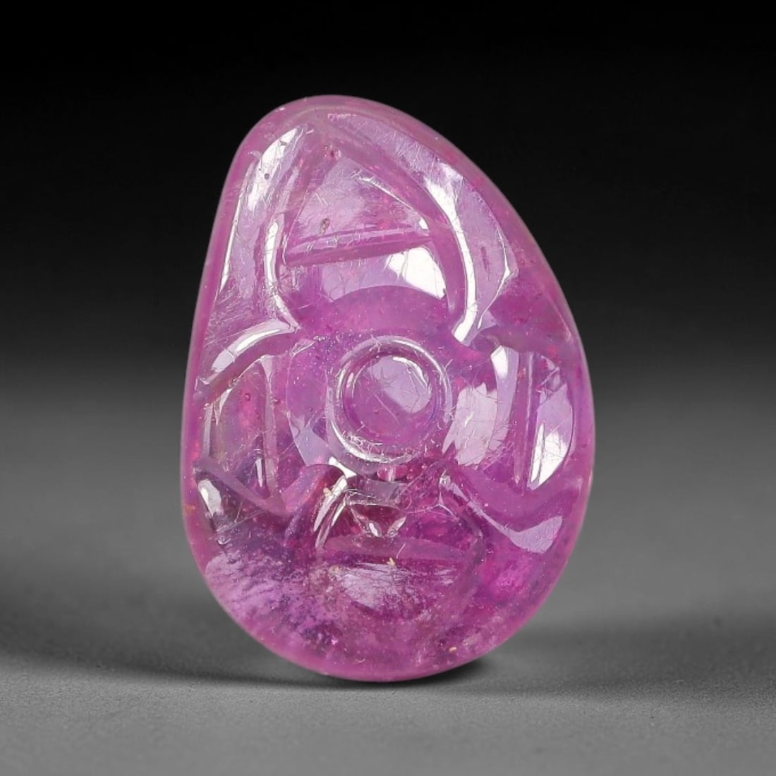 6.09 Carats Natural Mozambique Rich Fuchsia Ruby Loose Gemstone, 41FE: This natural Mozambique ruby cabochon measures 14.6x10.3x3.3mm and features delicate hand engraved floral detailing carved across its polished surface, with a rich saturated fuchsia hue spread evenly 