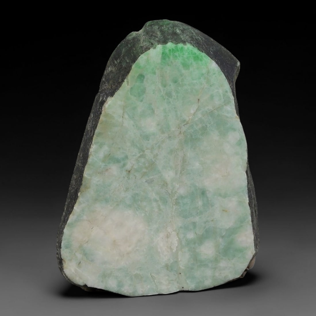 203ct Natural Type A Burmese Jadeite Jade Sliced Rough, 50AZ: This specimen is a sliced rough block of natural Type A Burmese jadeite jade. The interior displays natural colour zoning with visible mineral veining and crystalline patterns typical of unprocessed j