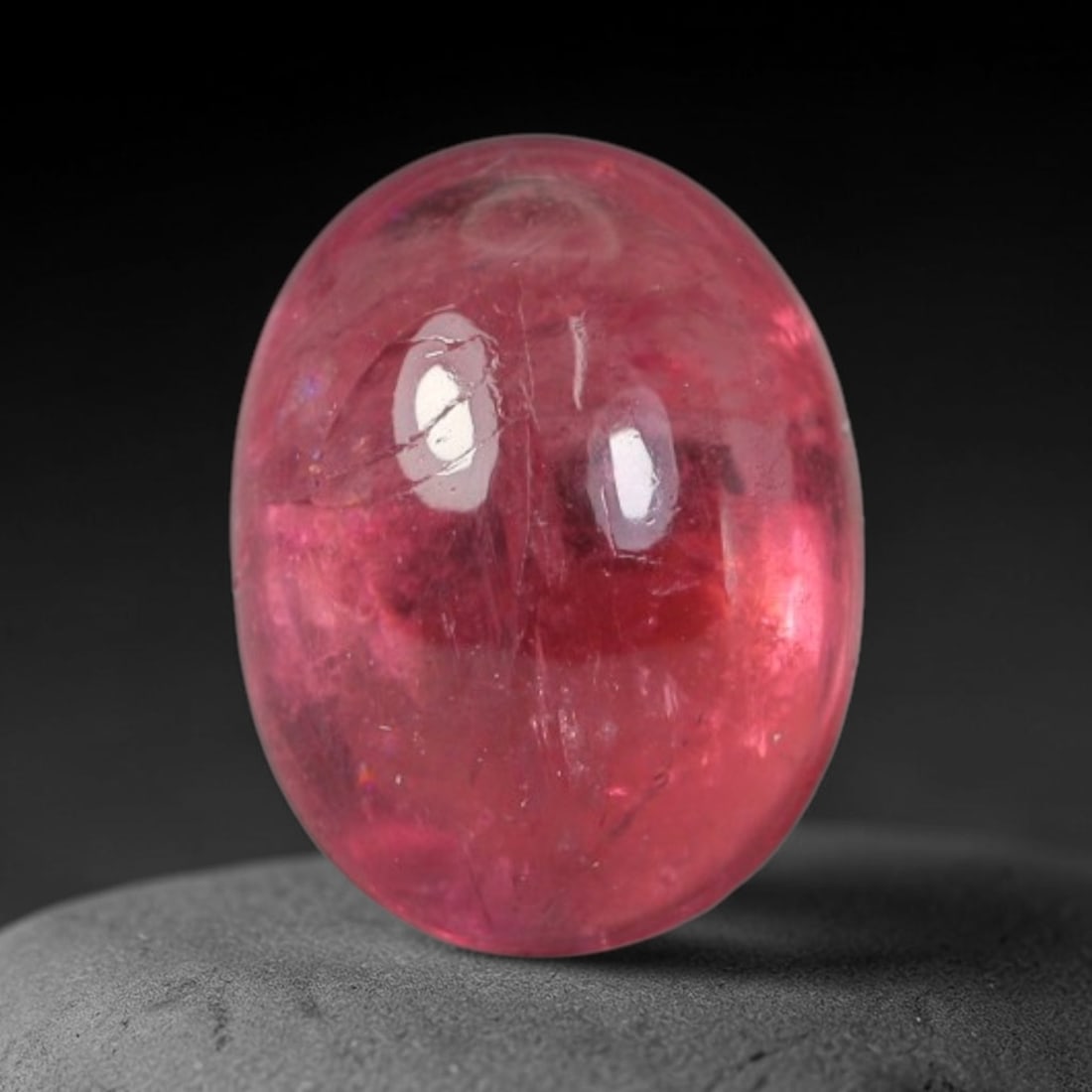 1.44ct Natural Brazilian Rubellite Tourmaline Cabochon Loose Gemstone, 46BC: This smoothly polished cabochon rubellite tourmaline features layered saturated pink-red body saturation with dense natural crystalline mineral flecks and fine internal fracture markings concentrated 