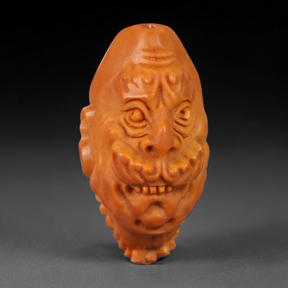 A Chinese Carved Natural Olive Nut Drilled Art Bead, 20BZ: Traditional craft bead carved from solid natural olive nut core, representing a classic miniature Chinese micro-carving folk art piece with a pre-drilled suspension bore integrated for easy threading 