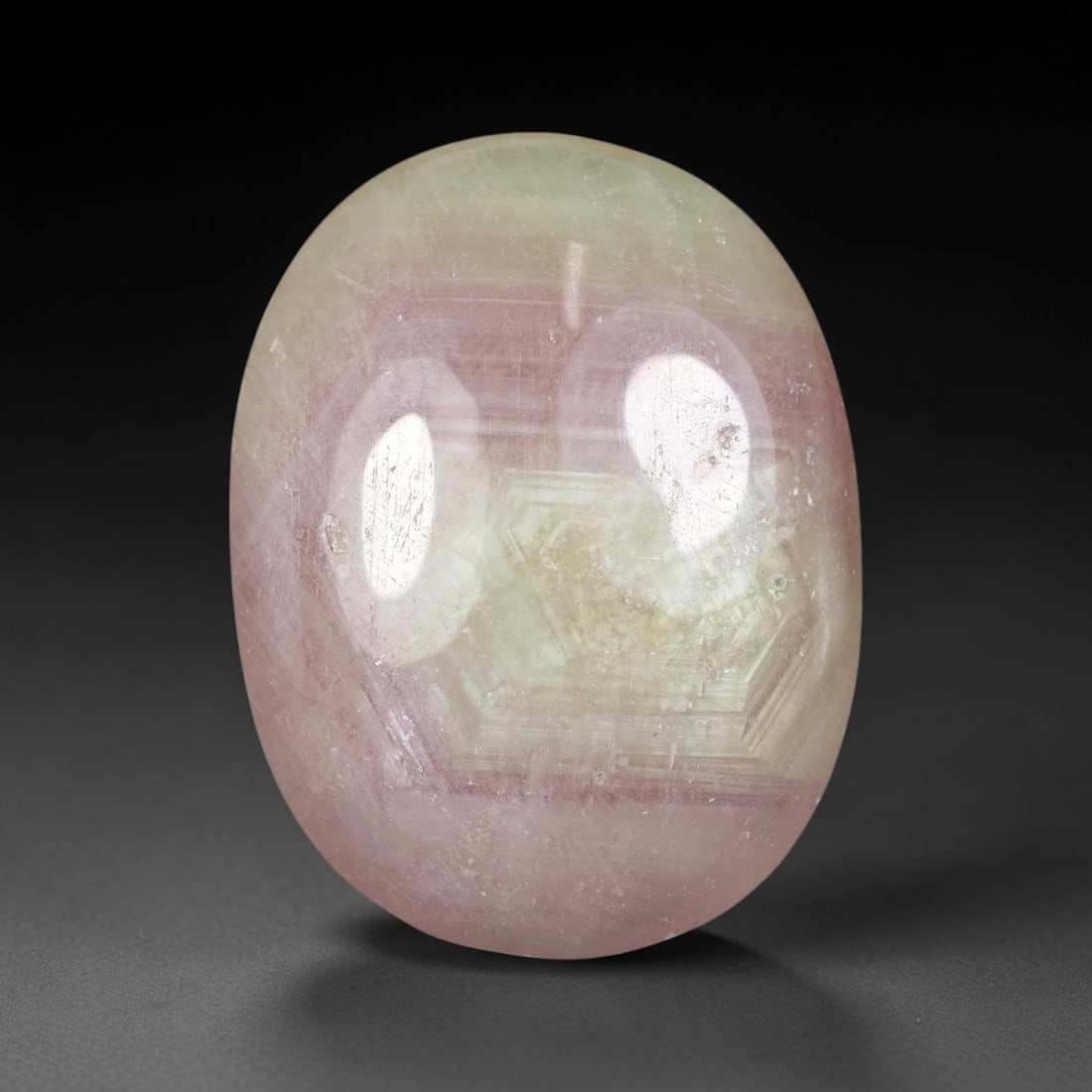 33.56 Carats Natural Madagascar Soft Rose Pink Heated Ruby Cabochon Loose Gemstone, 69FE: This warm blush-toned ruby cabochon carries blended swathes of soft rose pink and gentle peach undertones, with faint natural mineral veining throughout the polished dome, measured at 26.7x20.4x5.5mm.