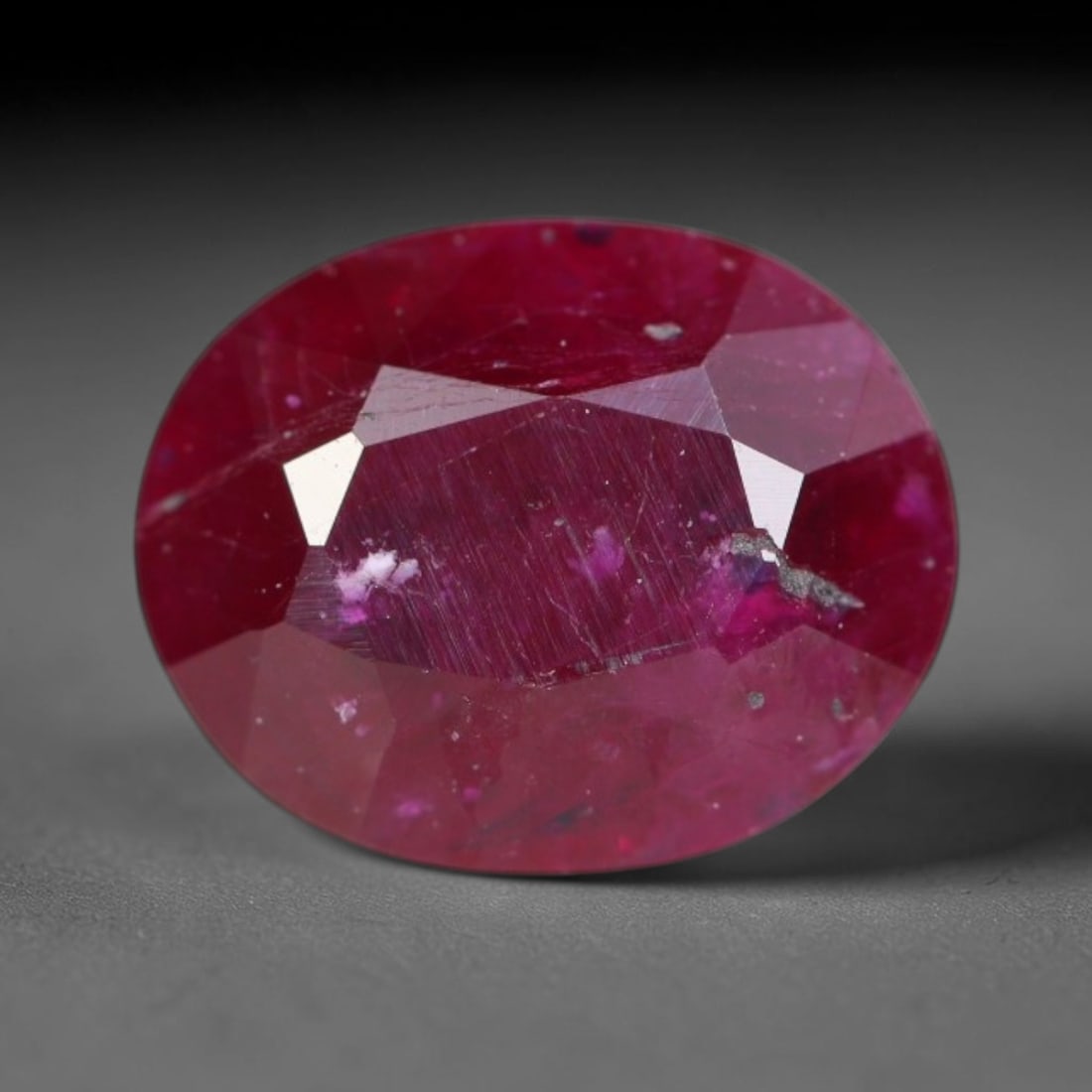 1.23ct Natural Tanzanian Longido Deep Crimson Red Faceted Ruby Loose Gemstone, 78BC: This expertly faceted Longido ruby features a rich deep crimson red body tone with distinct natural linear mineral striations, scattered pale mineral deposits and minor dark mineral flecks visible wit