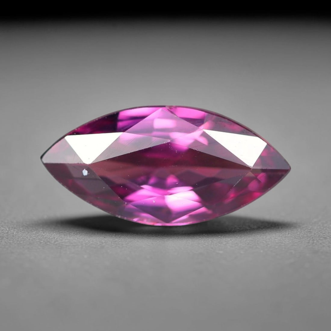 1.29ct Natural Tanzanian Rhodolite Grape Garnet Faceted Loose Gemstone, 99BF: This expertly faceted grape garnet, a scarce saturated purple-magenta rhodolite variant, features transparent crystal structure dotted with faint microscopic mineral specks within its precisely cut re