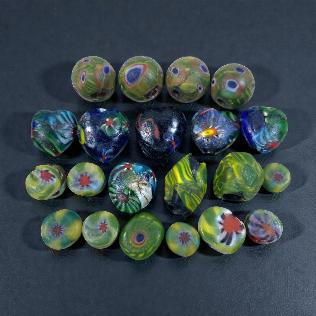 Lot of 21 Vintage Millefiori Glass Beads, Floral Eye Pattern Lampwork Beads, 90AA: Vintage bulk set of 21 handcrafted millefiori lampwork glass beads, measuring 1-1.5cm each with assorted shapes including round, heart, oval, teardrop and flat disc styles. Features vibrant green, blu