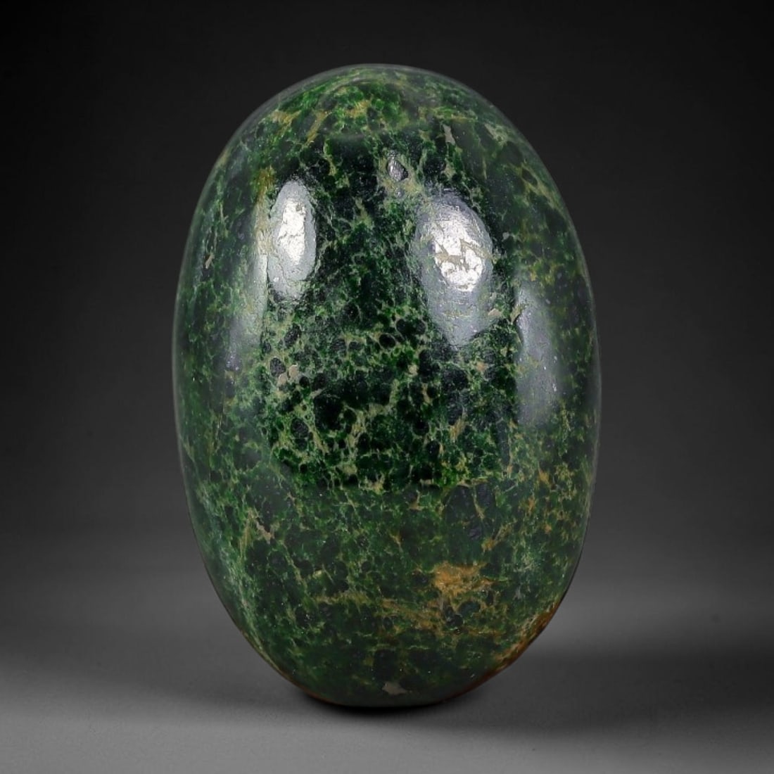 20.46ct Natural Burmese Type A Dark Green Net Vein Jadeite Jade Cabochon, 40FA: This single untreated natural Burmese Type A oval jadeite jade cabochon weighs 20.46ct with dimensions of 22x14.7x6.7mm. The dense dark green body is covered with fine yellowish-brown net-like veins, 