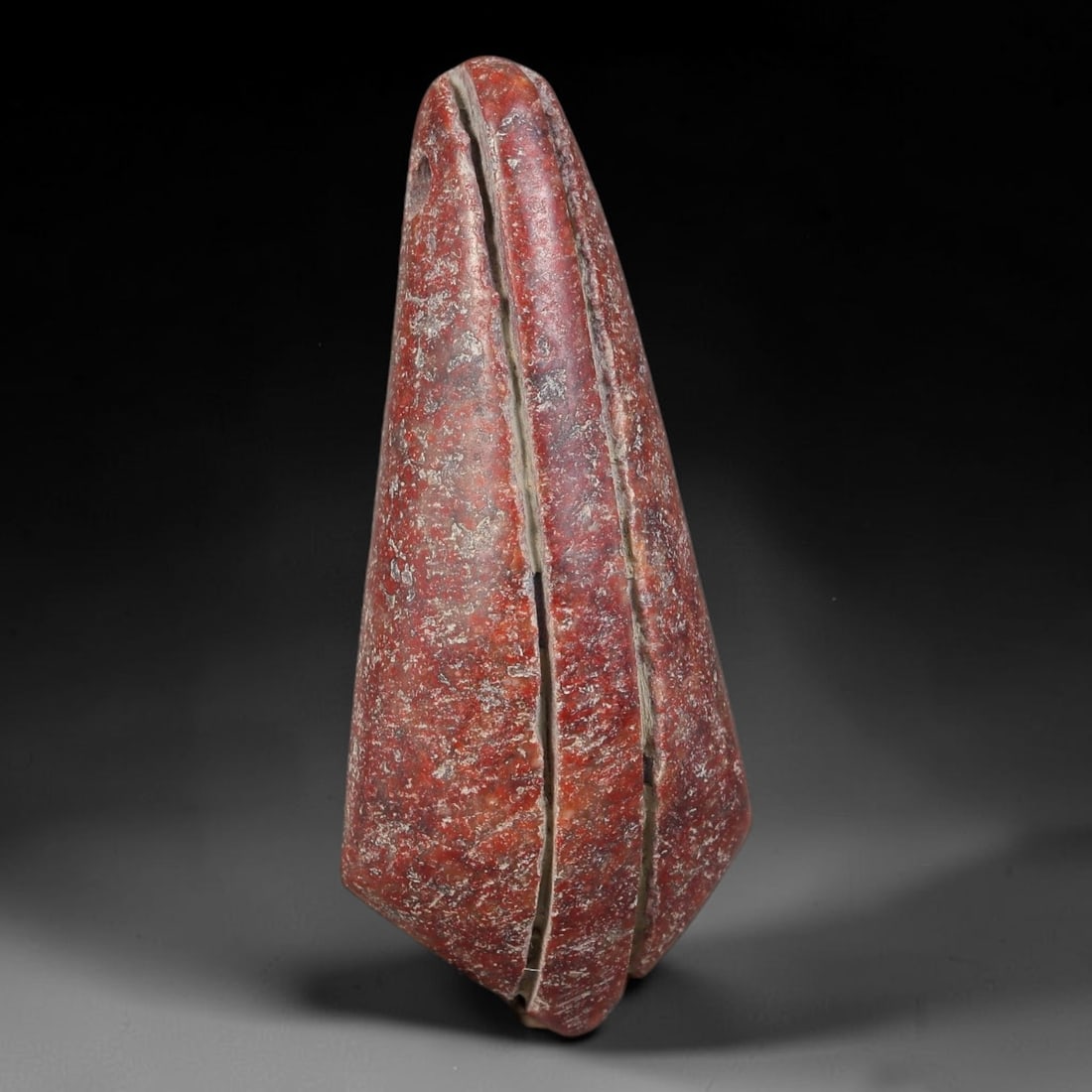 Ancient Nubian / Kushite Kingdoms Red Agate Conical Ritual Amulet (2000 BCE-400 CE), 14AT: This antique carved red agate conical ritual amulet originates from the Nubian / Kushite Kingdoms, Northeast African cultures that produced distinctive chalcedony talismans for elite personal adornmen