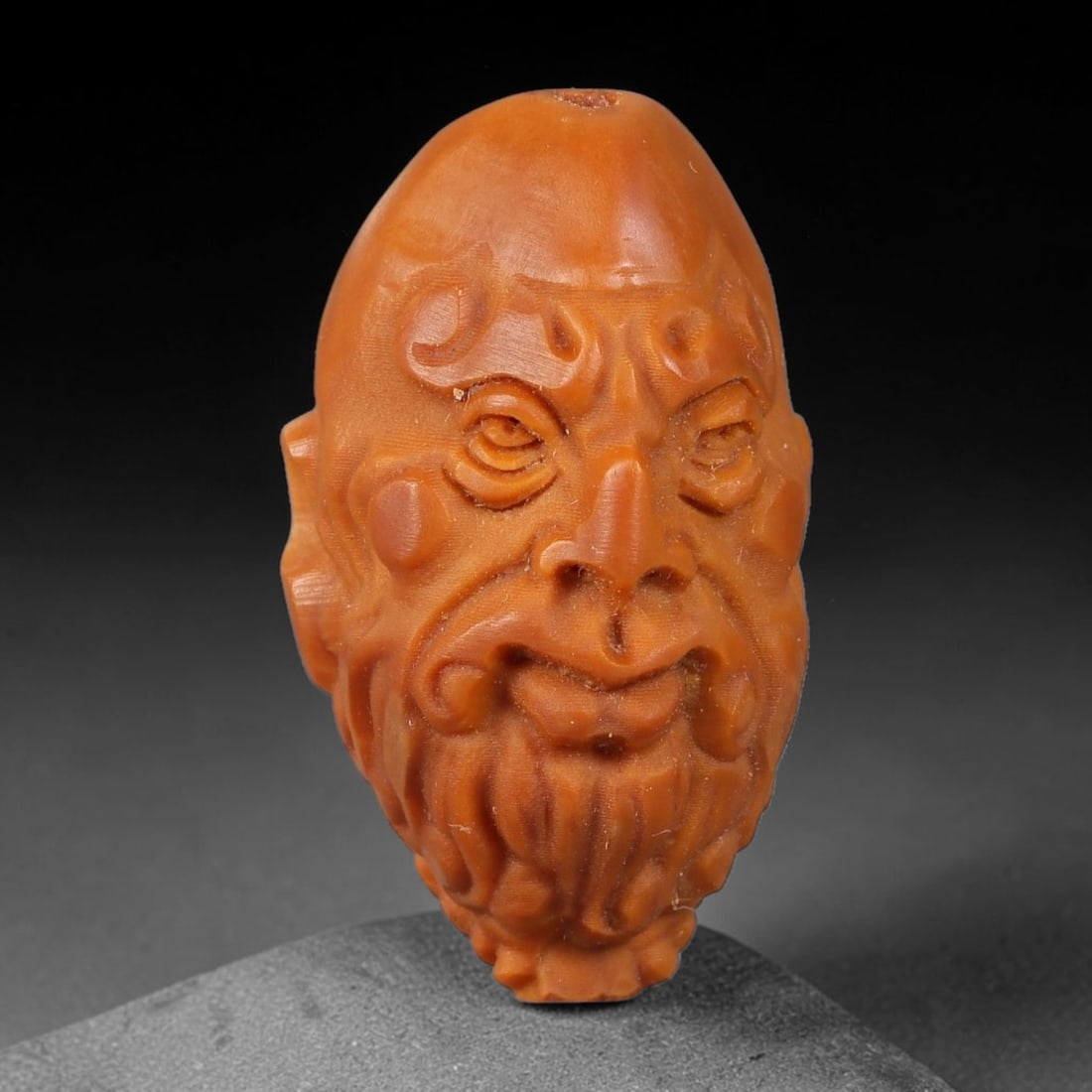 A Chinese Carved Natural Olive Nut Drilled Art Bead, 18BZ: Traditional craft bead carved from solid natural olive nut core, representing a classic miniature Chinese micro-carving folk art piece with a pre-drilled suspension bore integrated for easy threading 