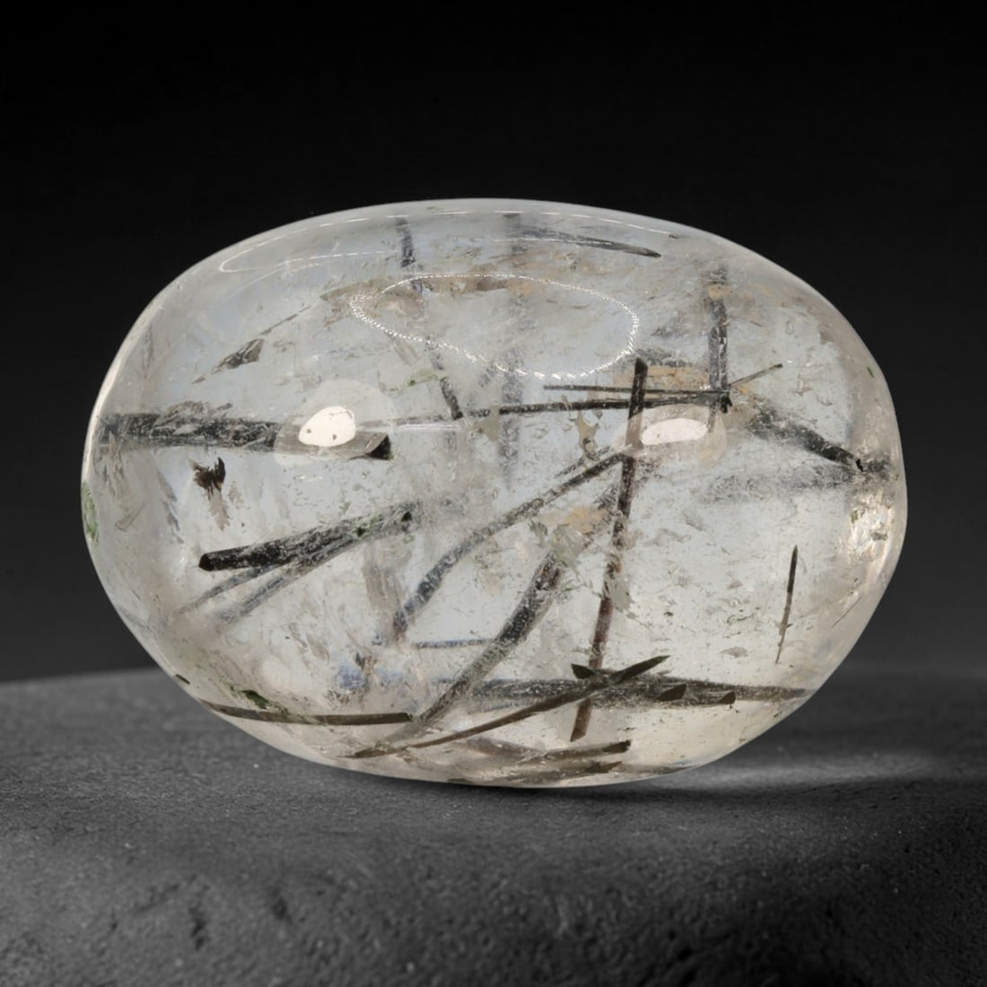 21ct Natural Brazilian Black Rutile Quartz Cabochon Loose Gemstone, 47BM: This polished cabochon of natural rutile quartz features countless distinct slender black rutile needle inclusions suspended within the clear quartz host crystal. The smooth domed surface enables full