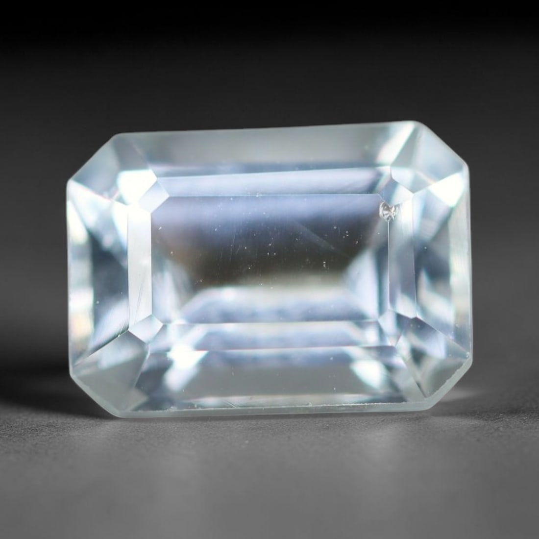 1.85ct Natural Brazilian Sky Blue Faceted Aquamarine Loose Gemstone, 10BC: This precisely faceted aquamarine boasts clear translucent pale sky blue body tone with subtle thin mineral needle and tiny scattered crystalline specks visible within its polished reflective planes i