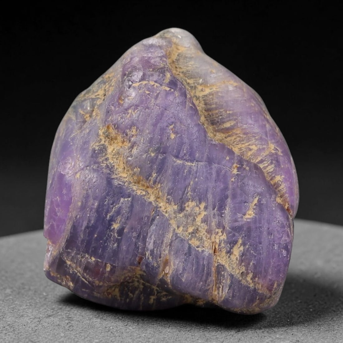 59.64ct Natural Unheated Sri Lankan Purplish Blue Sapphire Rough, 49FC: This natural corundum rough is an unheated purplish blue sapphire sourced from Sri Lankan alluvial gem deposits, featuring an irregular natural native form with residual pale yellow-brown mineral matr