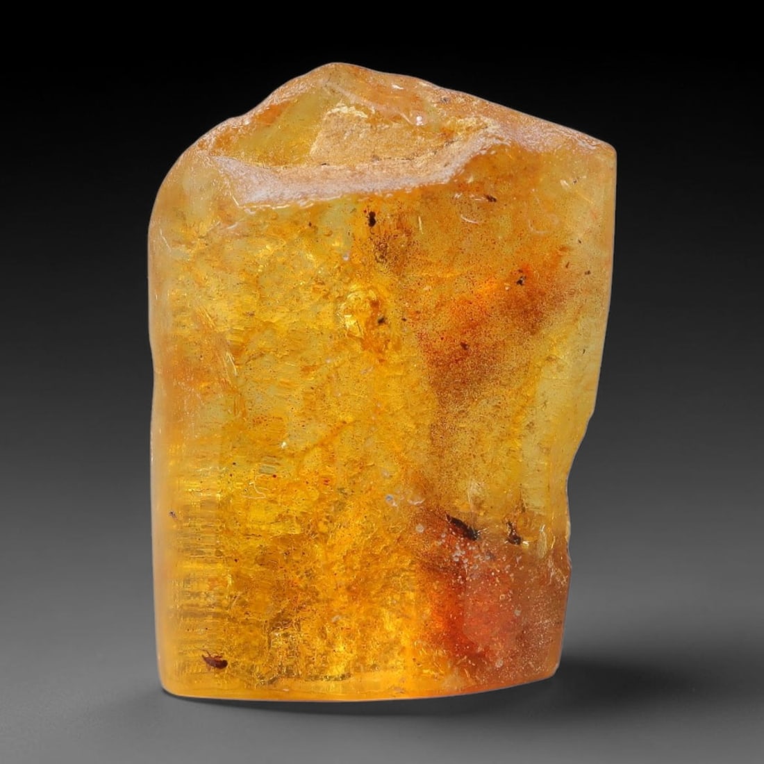 14.35ct Natural Baltic Polished Loose Freeform Amber Gemstone, 51EB: This smoothly polished freeform amber piece carries warm translucent organic clarity with fine natural fossil flecks and tiny mineral inclusions suspended throughout its 26x20mm flowing unstructured s
