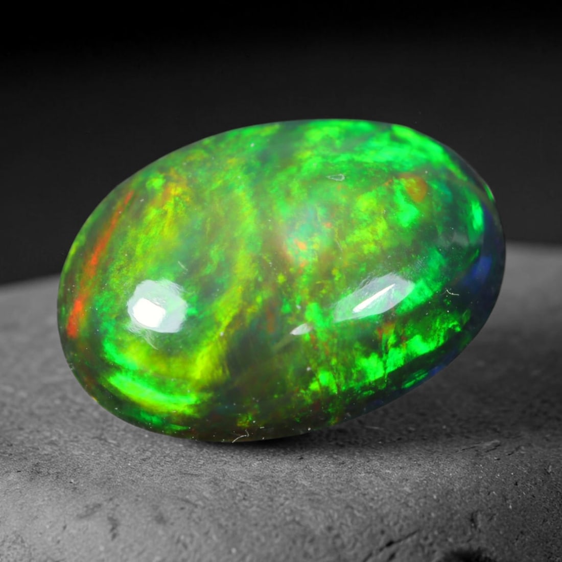 1.62ct Natural Ethiopian Welo Black Smoked Opal Cabochon Loose Gemstone, 33EJ: This fully polished Ethiopian Welo opal features a dark smoked base with vivid, sweeping play-of-color shifting across its glossy dome surface, measured at 10.7x8x3.5mm. The black smoke treatment deep