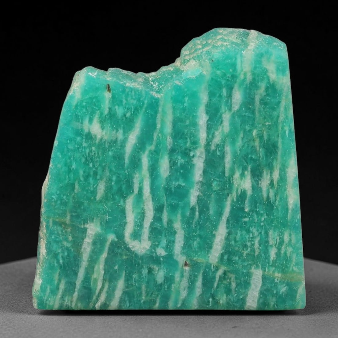 65ct Natural Russian Ural Amazonite Slab Rough, 75EB: This intact amazonite slab features distinct parallel mineral banding running uniformly across its naturally split flat surface within 28x27x10mm slab dimensions, retaining unmodified natural geologic