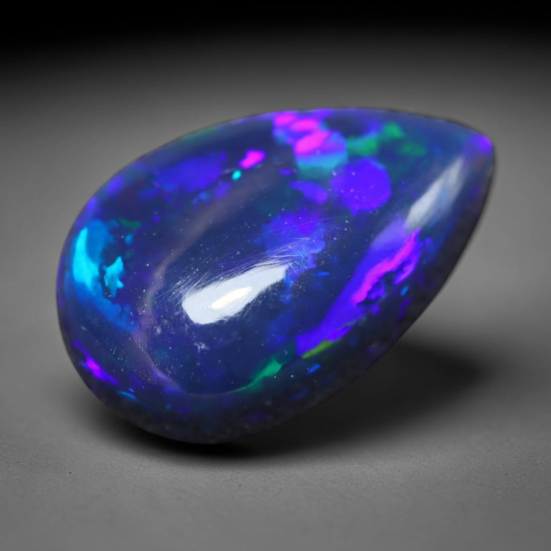 2.42ct Natural Ethiopian Welo Black Smoked Opal Cabochon Loose Gemstone, 71BY: This fully polished Ethiopian Welo opal features a dark smoked base with vivid, sweeping play-of-color shifting across its glossy dome surface, measured at 13x8x4mm. The black smoke treatment deepens 