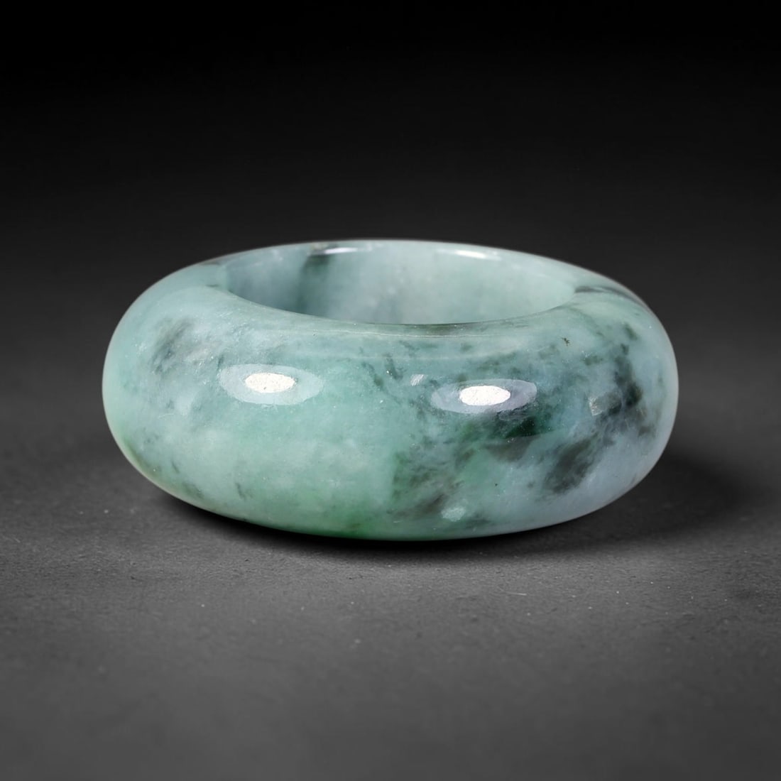 Natural Burmese Type A Jadeite Jade Wide Band Ring, 7BK: Polished untreated Burmese Type A jadeite jade wide band ring, US ring size 13 with a substantial band width of 13 mm. The jadeite features a soft pale mint green base naturally streaked with flowing 