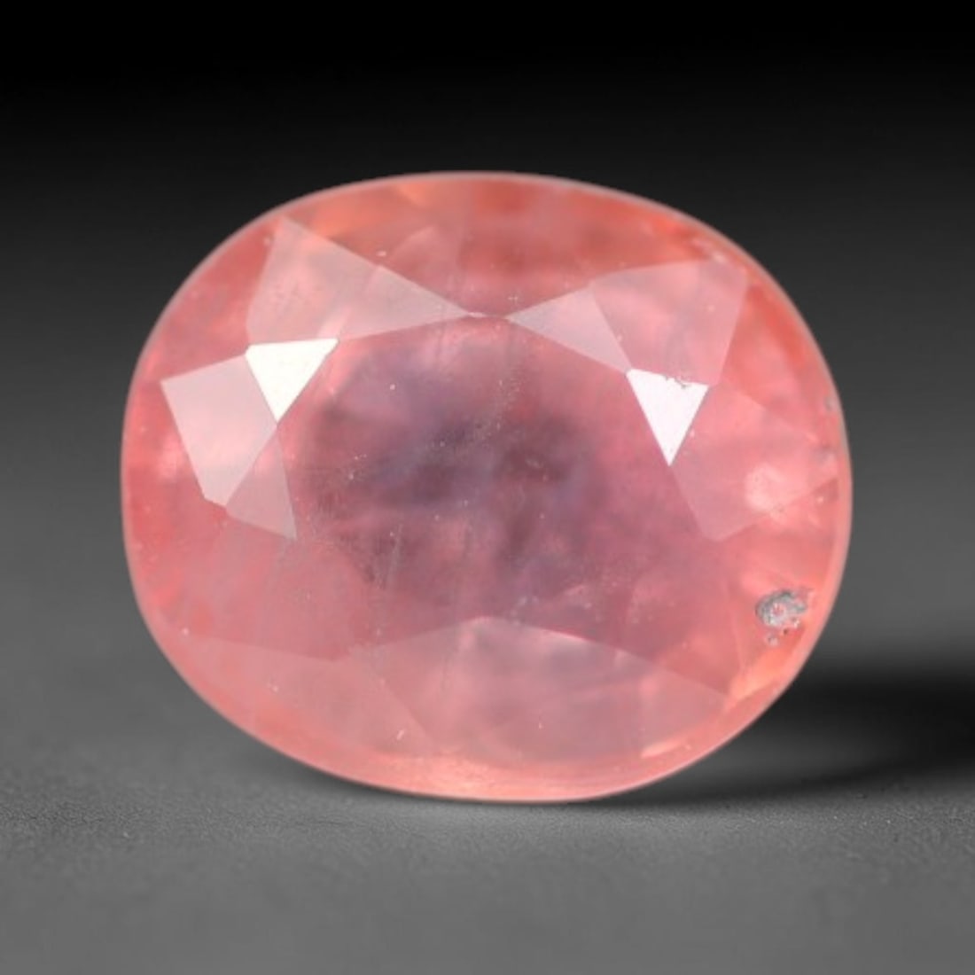 0.64ct Natural Sri Lankan Padparadscha Sapphire Loose Gemstone, 67BC: This fully polished Padparadscha sapphire carries warm blended peach-pink and soft orange body saturation, with subtle microscopic mineral flecks dispersed within its crystalline interior across its c