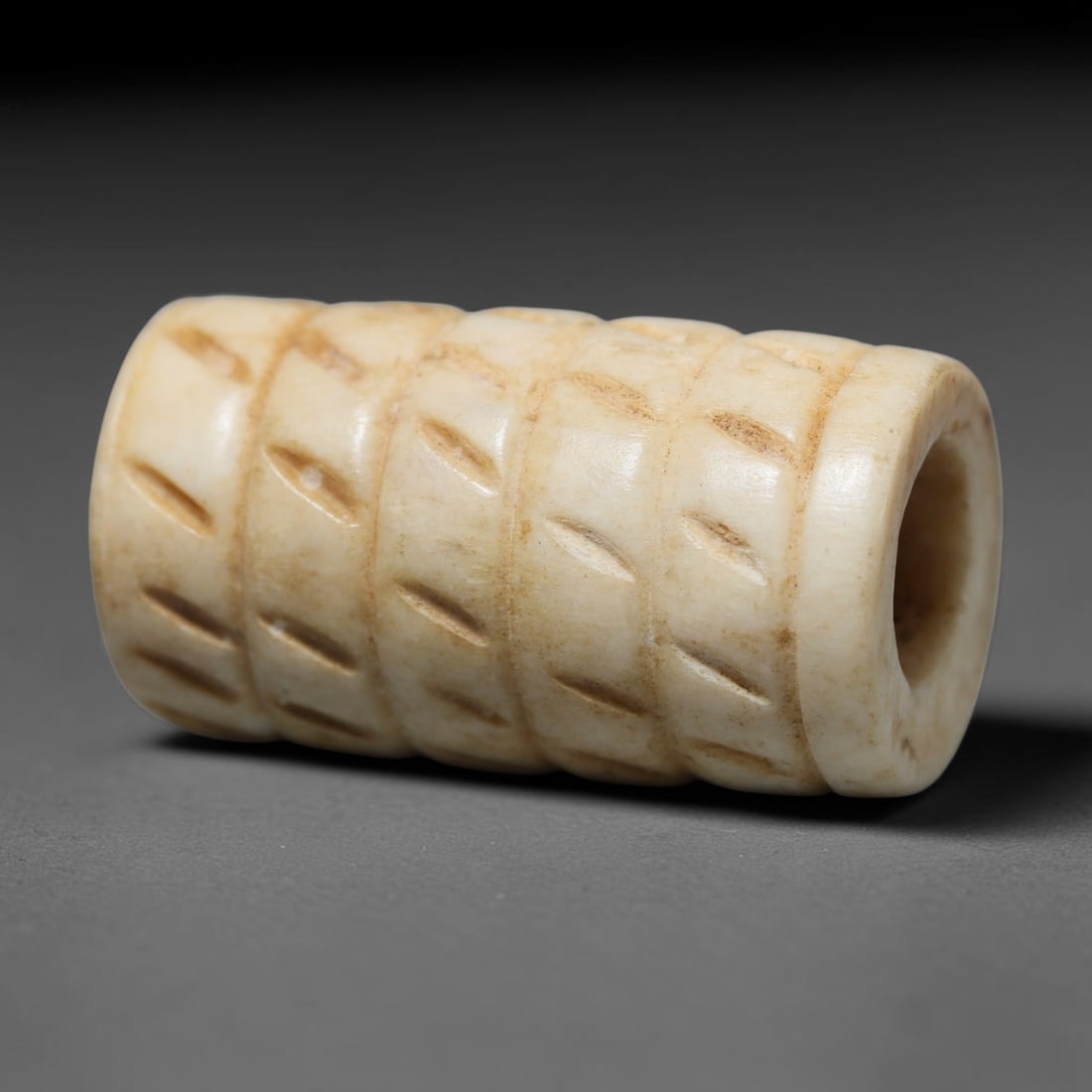 Antique Sino-Siberian Steppe Nomadic Craft Stag Antler Carved Cylinder Bead (Post 1850s), 75FV: Single bead carved from natural stag antler, originating from Sino-Siberian Steppe Nomadic craft traditions, post 1850s. Measuring 3x2cm, the piece features detailed surface carving and carries warm n