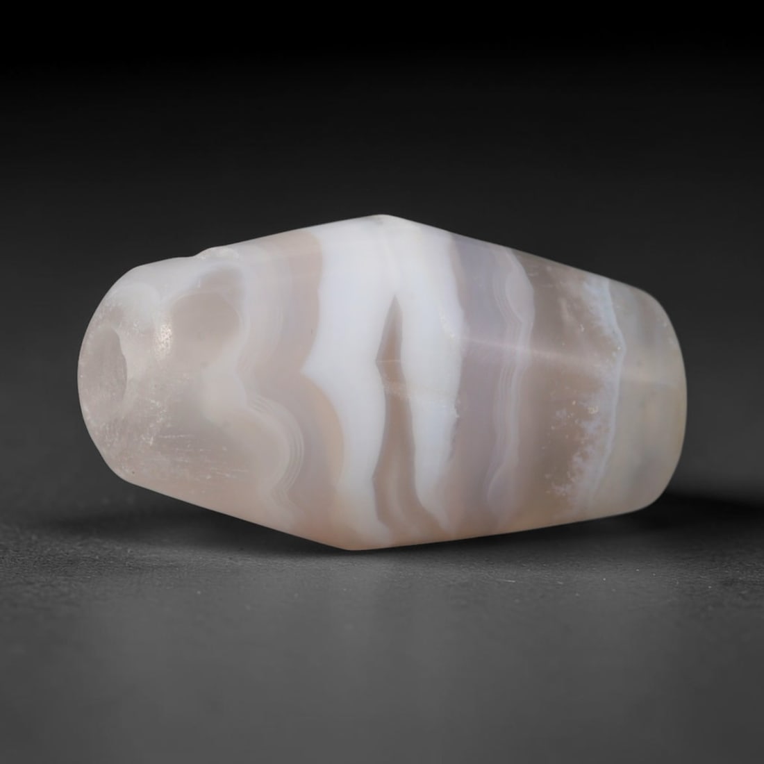 Ancient Hittite Bronze Age Civilization Banded Agate Barrel Bead (1600-1178 BCE), 54AD: This antique banded agate barrel bead originates from the Hittite Bronze Age Civilization of Anatolia, a prominent ancient power with sophisticated lapidary workshops producing ritual talismans and el