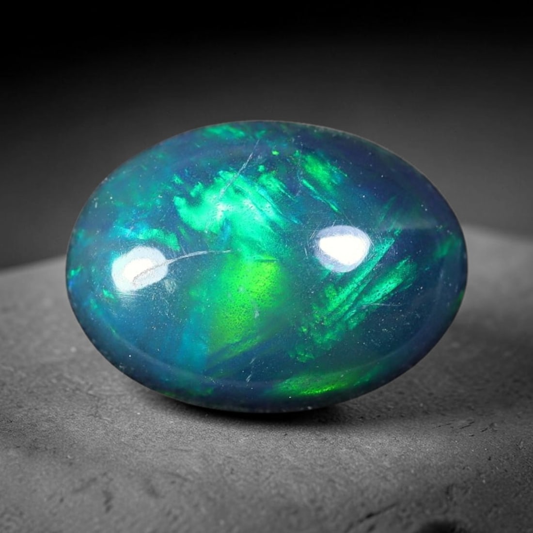1.25ct Natural Ethiopian Welo Black Smoked Opal Cabochon Loose Gemstone, 71FX: This fully polished Ethiopian Welo opal features a dark smoked base with vivid, sweeping play-of-color shifting across its glossy dome surface, measured at 10x8x3mm. The black smoke treatment deepens 