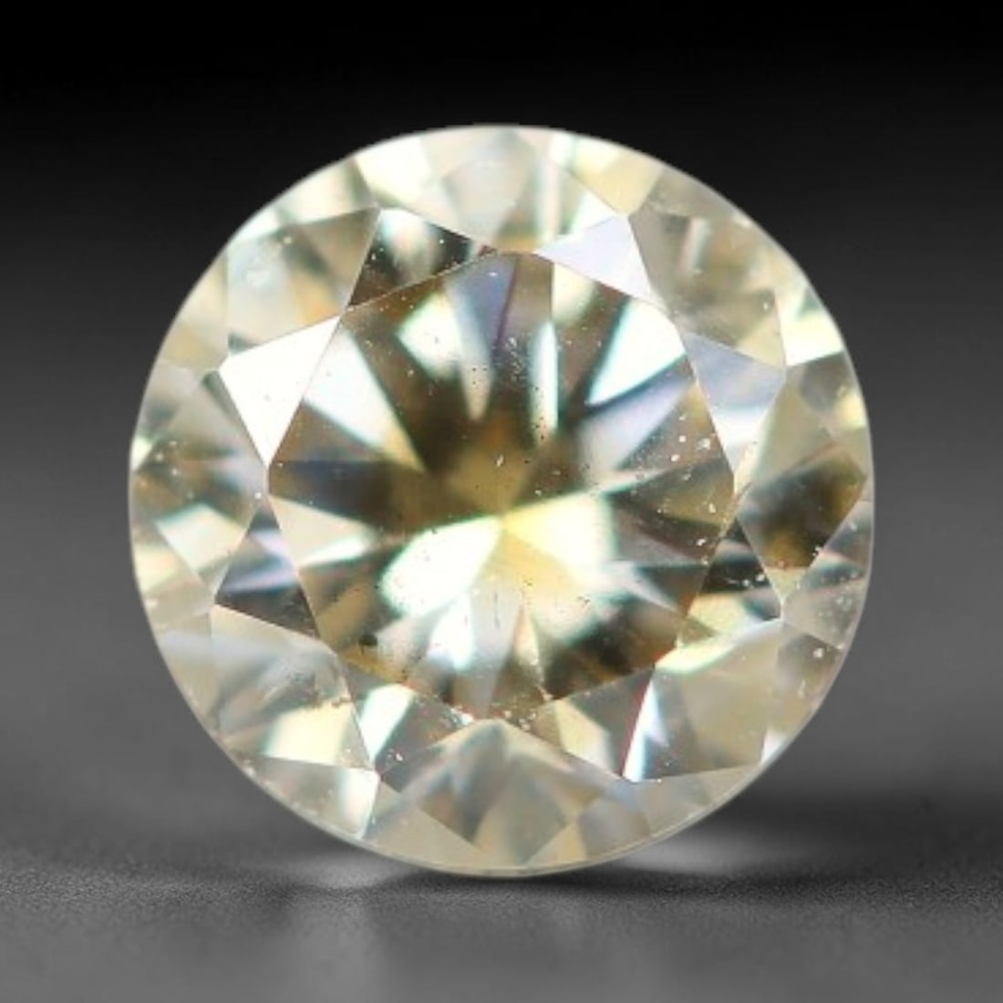 0.17ct Round Natural Fancy Pale Yellow Diamond Loose Gemstone, 38BH: This polished natural round fancy diamond exhibits soft pale yellow body tone, with scattered fine native mineral specks visible throughout its crystal interior, measured at calibrated dimensions of 3