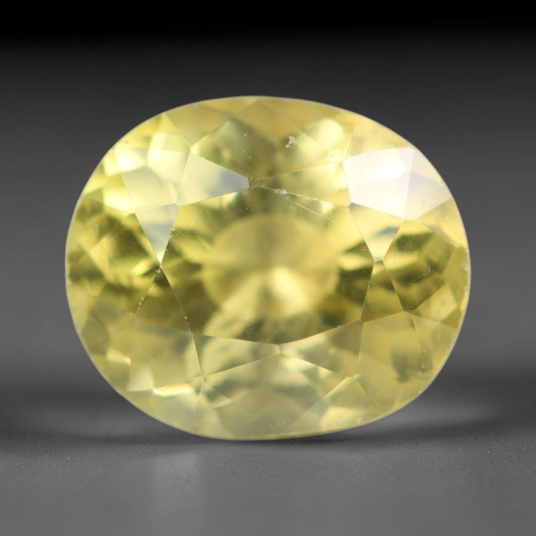 2.16ct Natural Mexican Lemon Yellow Faceted Apatite Loose Gemstone, 100AR: This expertly faceted yellow apatite holds translucent pale lemon yellow crystal structure with faint tiny internal mineral specks and subtle fine linear markings visible beneath its precisely polishe