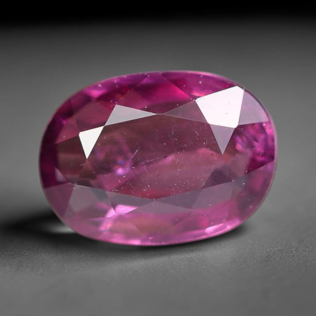 1.05ct Natural Tanzanian Rhodolite Grape Garnet Faceted Loose Gemstone, 10BE: This expertly faceted grape garnet, a scarce saturated purple-magenta rhodolite variant, features transparent crystal structure dotted with faint microscopic mineral specks within its precisely cut re