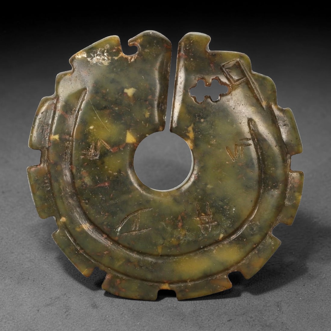 A Chinese Hardstone Bi-Form Disc, Reverse Side, Possibly Late Qing to Early Republic Period, 87FC: The reverse of the hardstone bi-form disc reveals the mottled olive-green stone with scattered russet, yellow, and darker mineral inclusions more prominently, largely left undecorated to emphasize the