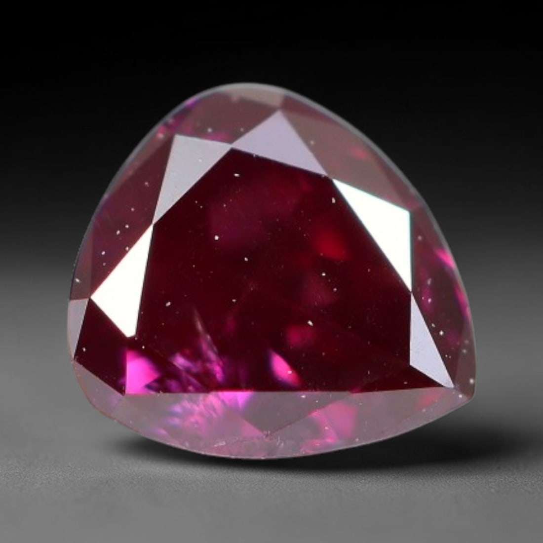 0.22ct Natural Fancy Deep Pink Diamond Loose Gemstone, 27BH: This polished natural fancy diamond features rich deep pink colouration, measured at calibrated dimensions of 4x3.6x1.9mm. Carefully proportioned pear faceting delivers dynamic light movement, highlig