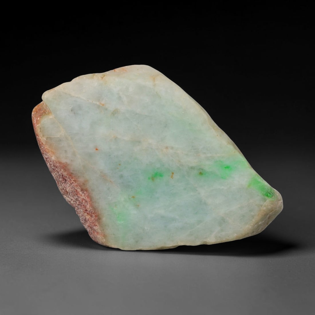330ct Natural Type A Burmese Jadeite Jade Sliced Rough, 55FD: This specimen is a sliced rough block of natural Type A Burmese jadeite jade. The interior displays natural colour zoning with visible mineral veining and crystalline patterns typical of unprocessed j