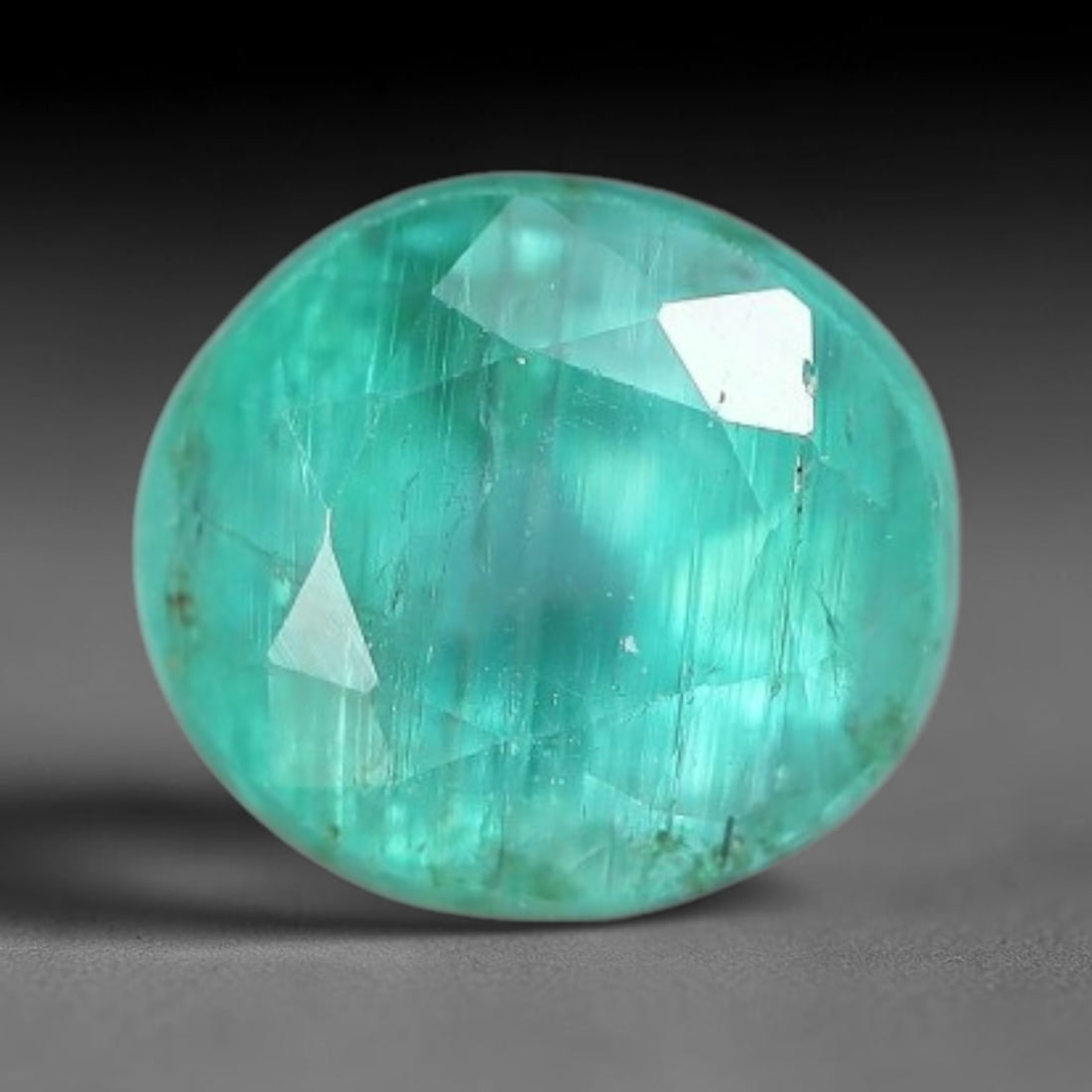 0.77 Carats Natural Zambian Green Emerald Loose Gemstone, 54AH: This green Zambian emerald holds smooth even saturation with subtle faint natural internal markings lending authentic organic character, measured at 5.1x4.5mm, its calm cool green tone delivers unders