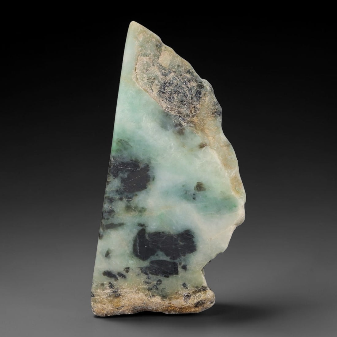 300ct Natural Type A Burmese Jadeite Jade Sliced Rough, 96FA: This specimen is a sliced rough block of natural Type A Burmese jadeite jade. The interior displays natural colour zoning with visible mineral veining and crystalline patterns typical of unprocessed j