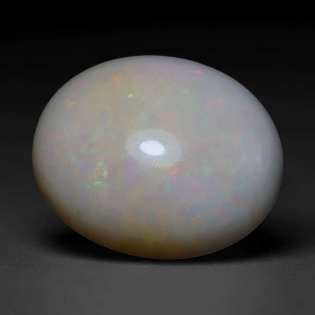 33.33ct Natural Ethiopian Welo Opal Cabochon Loose Gemstone, 61BY: This smoothly polished cabochon is genuine natural Ethiopian Welo opal. The translucent base hosts vivid multi-coloured play-of-colour, displaying dynamic flashes of multi color that shift as the view