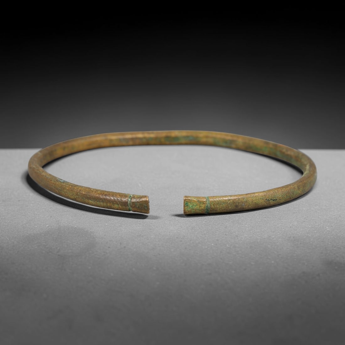 Ancient Roman Republic & Imperial Roman Bronze Open Armilla Bracelet (509 BCE-476 CE), 3AC: This antique solid bronze open cuff armilla bracelet originates from Roman Republic & Imperial Roman Culture, widely produced utilitarian and symbolic adornment worn by civilian women and awarded as m