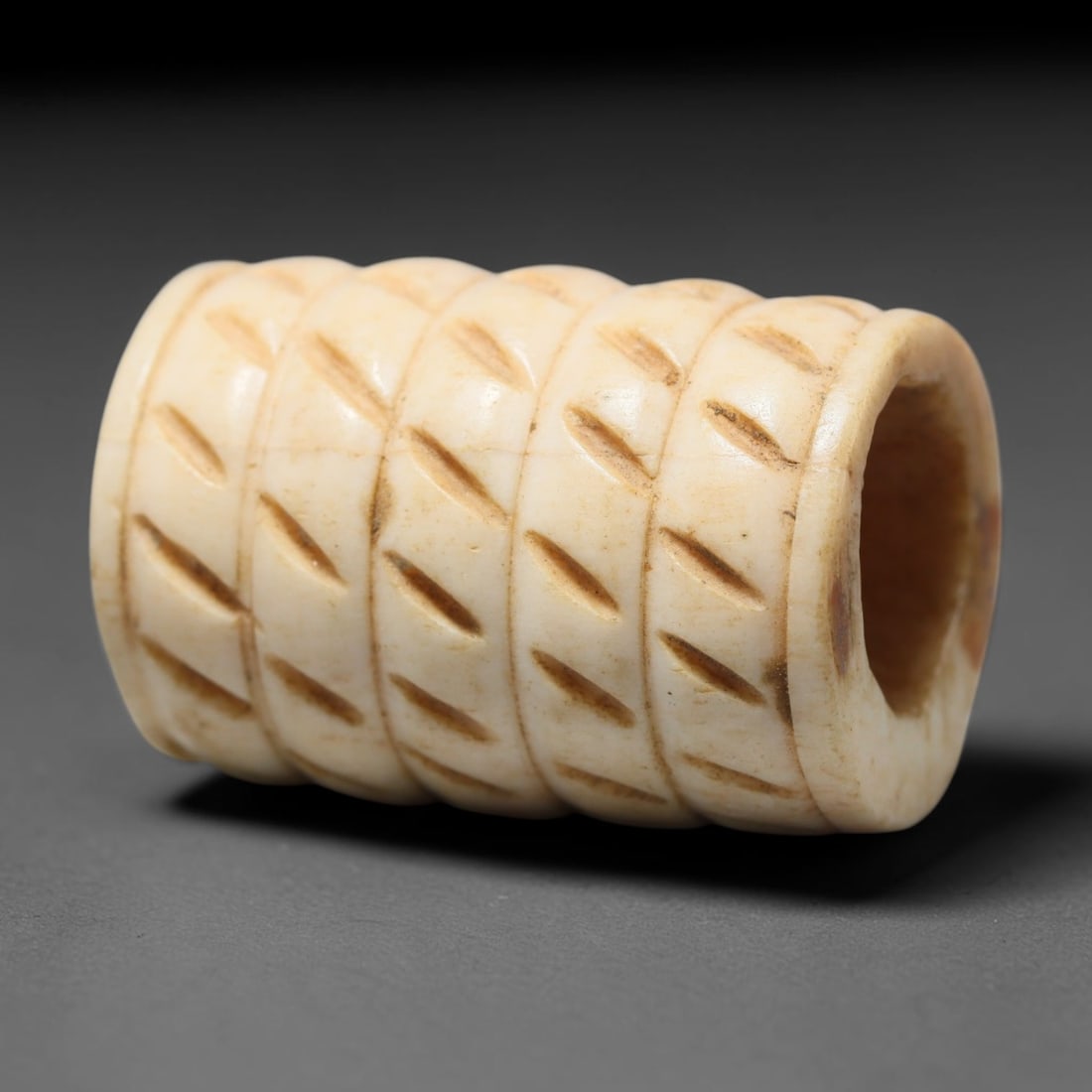Antique Sino-Siberian Steppe Nomadic Craft Stag Antler Carved Cylinder Bead (Post 1850s), 77FV: Single bead carved from natural stag antler, originating from Sino-Siberian Steppe Nomadic craft traditions, post 1850s. Measuring 3x2cm, the piece features detailed surface carving and carries warm n