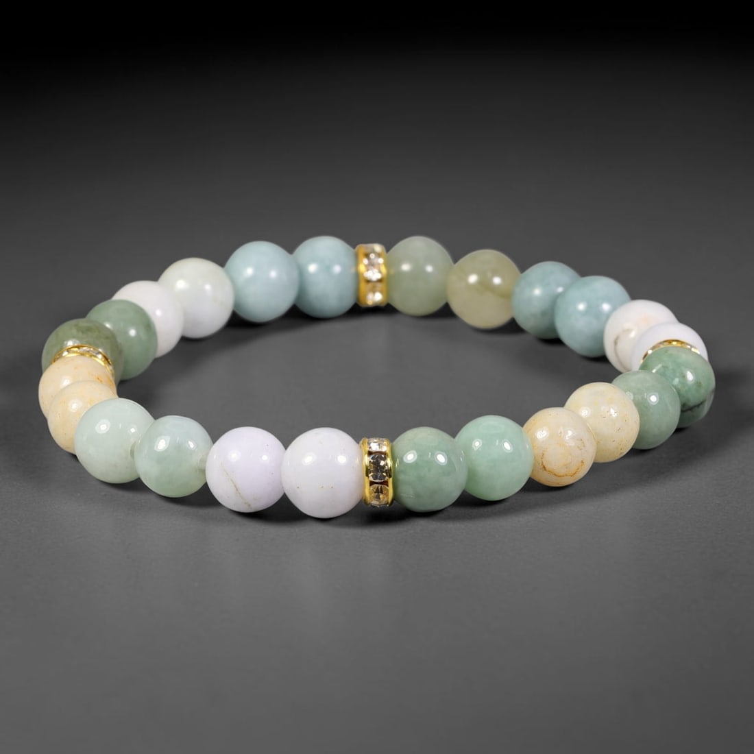 Natural Burmese Type A Jadeite Jade Stretch Bracelet with Gold Tone Crystal Spacers, 100FV: Elastic stretch bracelet made with smooth 8mm natural Burmese Type A jadeite jade round beads, decorated with polished gold-toned crystal spacer accents. Each bead showcases natural organic variations