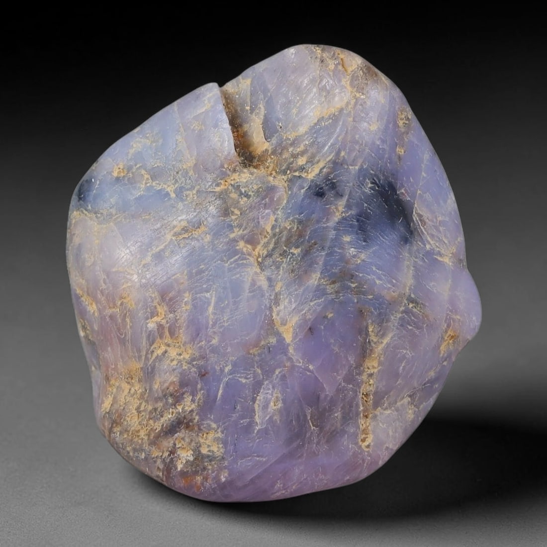 52ct Natural Unheated Sri Lankan Purplish Blue Sapphire Rough, 36FC: This natural corundum rough is an unheated purplish blue sapphire sourced from Sri Lankan alluvial gem deposits, featuring an irregular natural native form with residual pale yellow-brown mineral matr