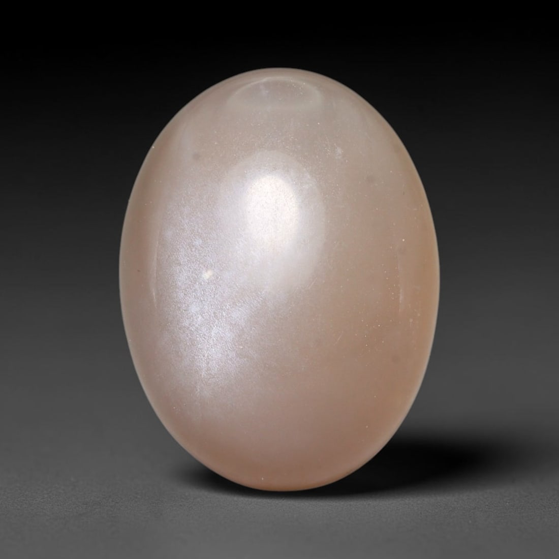 15.31ct Natural Ceylon Warm Peach Moonstone Loose Gemstone, 10FY: This natural Ceylon moonstone has dimension measurements of 17x13x9mm, showcasing a smooth warm peach base tone paired with subtle soft adularescent sheen that glides gently across the polished surfac