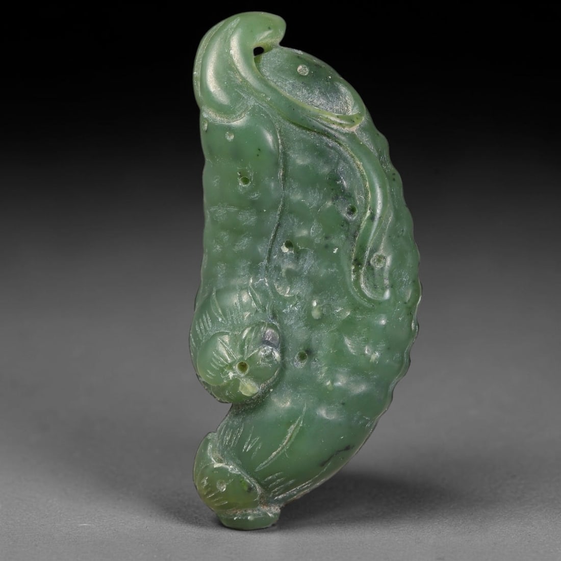 Natural Chinese Hand Carved Green Nephrite Jade Gourd Bat Motif Pendant, 86AT: Artisan hand-carved natural green nephrite jade pendant with an elegant curved organic silhouette, measuring 52 x 22 mm. The piece is sculpted into a stylized gourd form dotted with small natural text