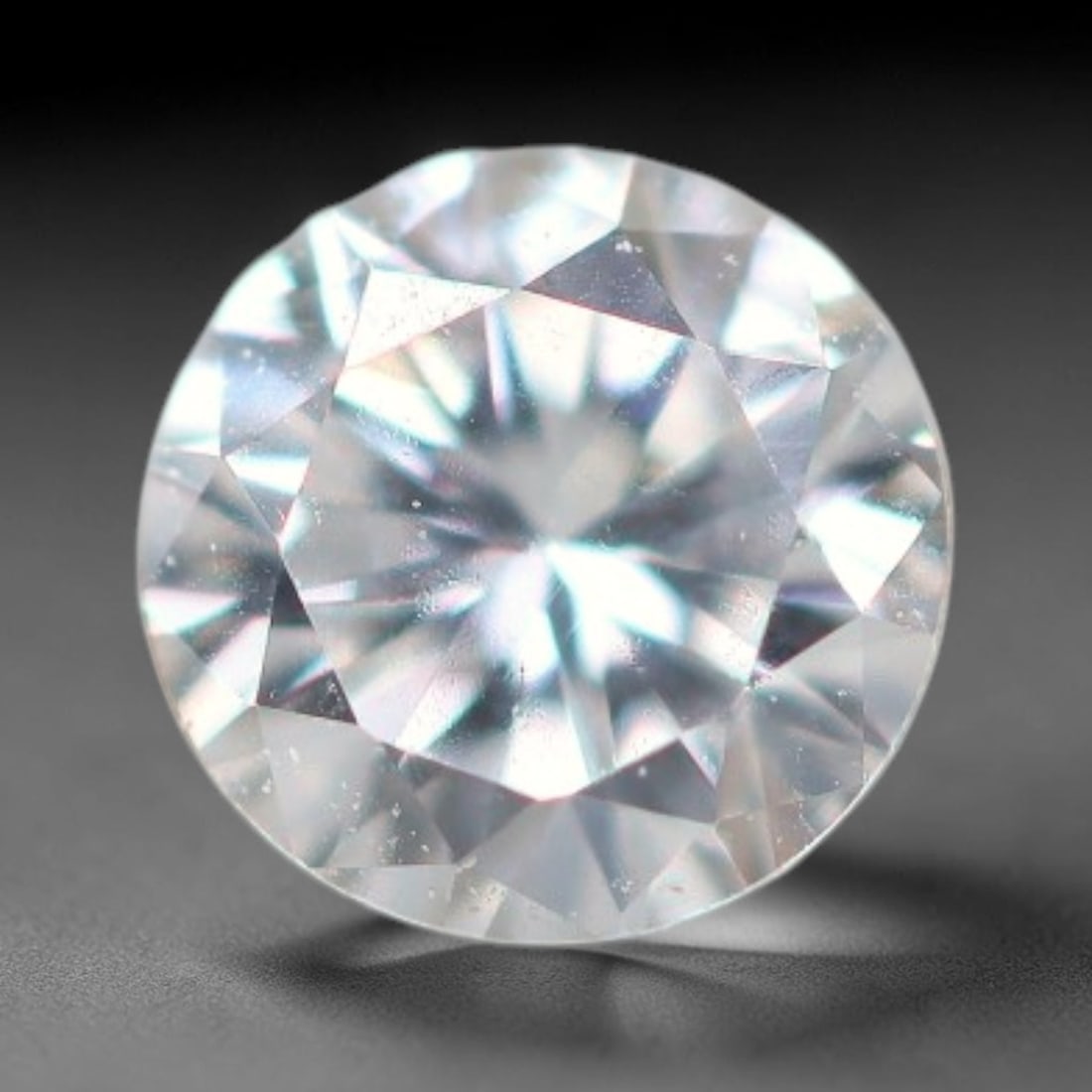0.13ct Lab-Grown White Round Brilliant HPHT Diamond Loose Gemstone, 80BE: This precision-cut HPHT lab-grown diamond exhibits brilliant colourless transparency, dotted with subtle microscopic growth features within its crystal structure, measured at calibrated dimensions of 