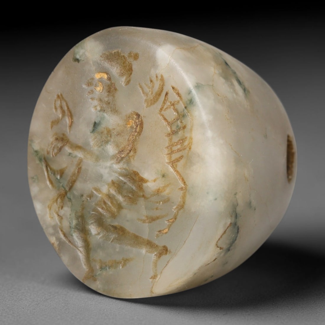 Ancient Sasanian Persian Moss Agate Conoid Stamp Seal (224-651 CE), 62EC: This pierced conoid stamp seal is carved from natural moss agate and originates from the Sasanian Persian Empire. The sealing face bears an intaglio winged divine figure, a widespread guardian motif i