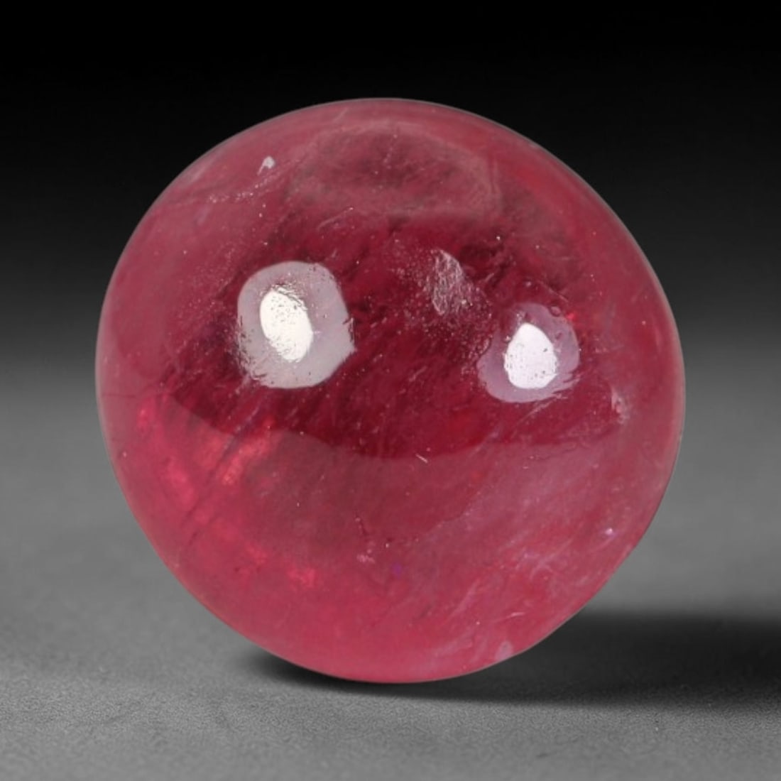 1.89ct Natural Brazilian Rubellite Tourmaline Cabochon Loose Gemstone, 37BC: This smoothly polished cabochon rubellite tourmaline features layered saturated pink-red body saturation with dense natural crystalline mineral flecks and fine internal fracture markings concentrated 