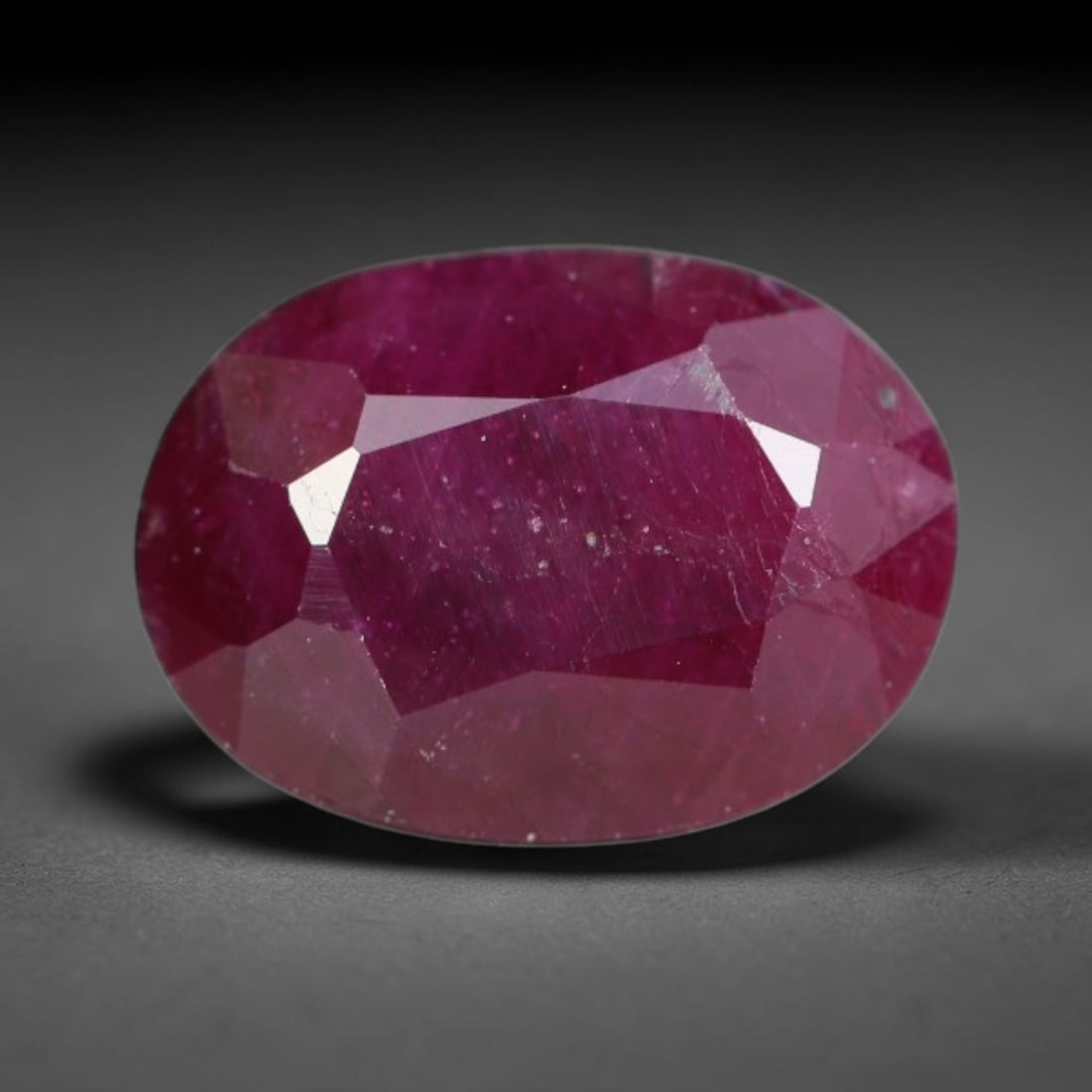 1.27ct Natural Tanzanian Longido Deep Crimson Red Faceted Ruby Loose Gemstone, 80BC: This expertly faceted Longido ruby features a rich deep crimson red body tone with distinct natural linear mineral striations, scattered pale mineral deposits and minor dark mineral flecks visible wit