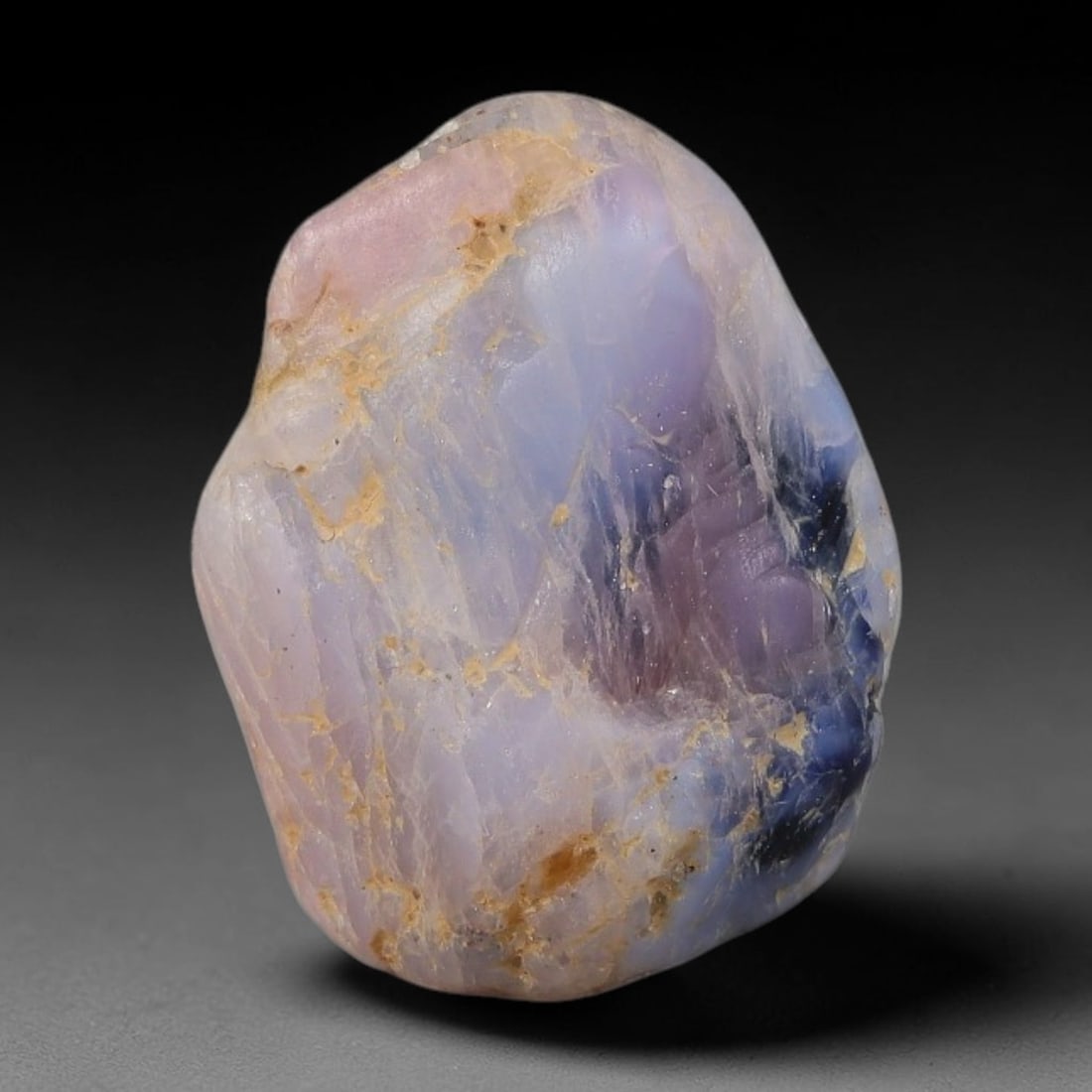 22.63ct Natural Unheated Sri Lankan Purplish Blue Sapphire Rough, 75FC: This natural corundum rough is an unheated purplish blue sapphire sourced from Sri Lankan alluvial gem deposits, featuring an irregular natural native form with residual pale yellow-brown mineral matr