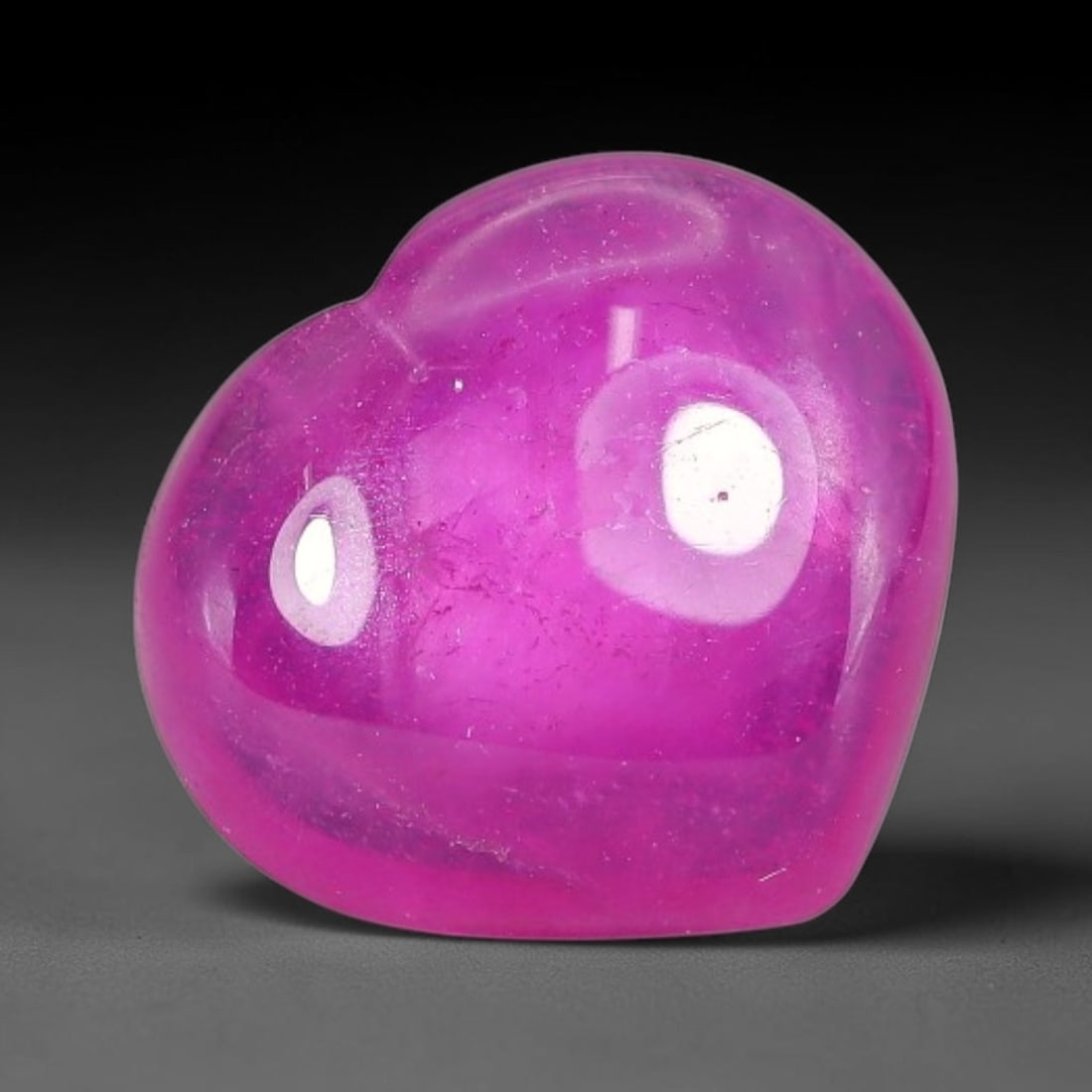 5.77 Carats Natural Mozambique Hot Pink Ruby Loose Gemstone, 61FE: This heart shaped Mozambique ruby cabochon measures 11.5x10.4x4.2mm, showcasing a vivid saturated hot pink body paired with stunning natural hexagonal crystal growth banding that forms a distinct geom