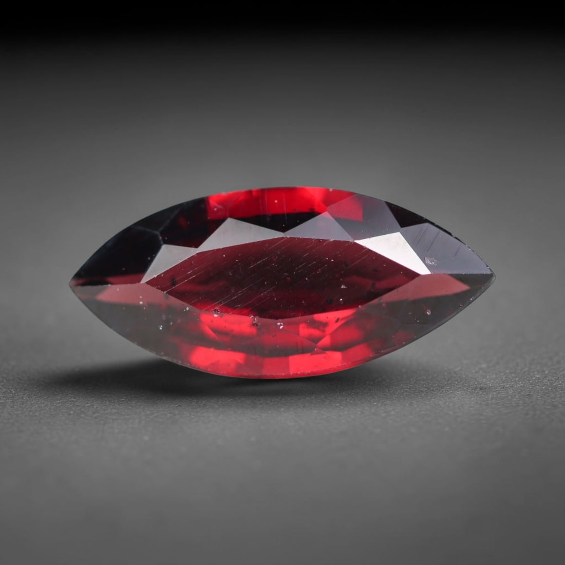 4.93ct Natural Mozambican Deep Crimson Red Faceted Almandine Garnet Loose Gemstone, 100BC: This meticulously faceted garnet features a dense, rich red crystalline body dotted with subtle micro mineral inclusions scattered evenly throughout its transparent interior, precision-cut reflective 